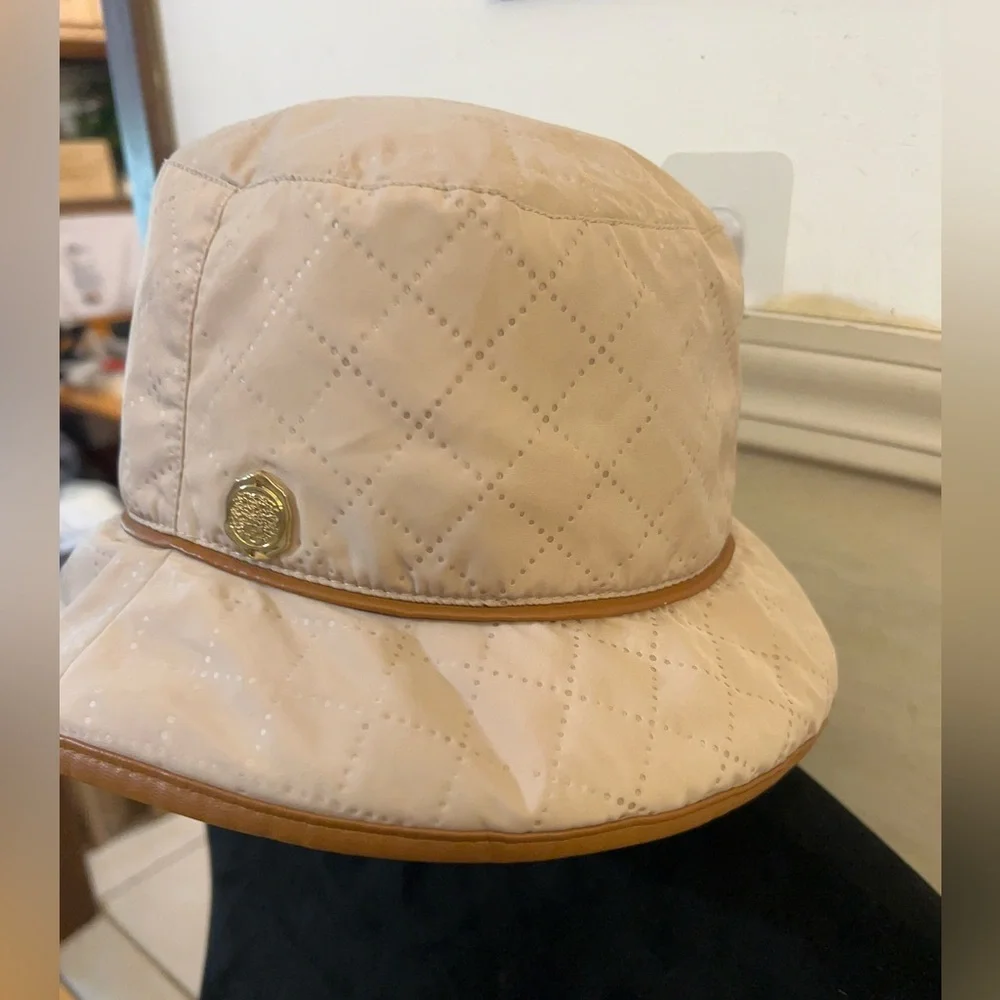 Vince Camuto Quilted Cream Bucket Hat with Tan Trim and Gold Emblem